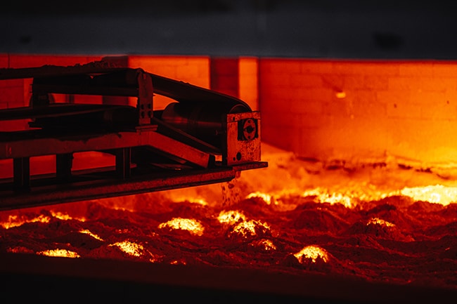 Figure 1. Automated addition of raw materials to a DURAN™ glass melting tank. Figure 1. Automated addition of raw materials to a DURAN™ glass melting tank.